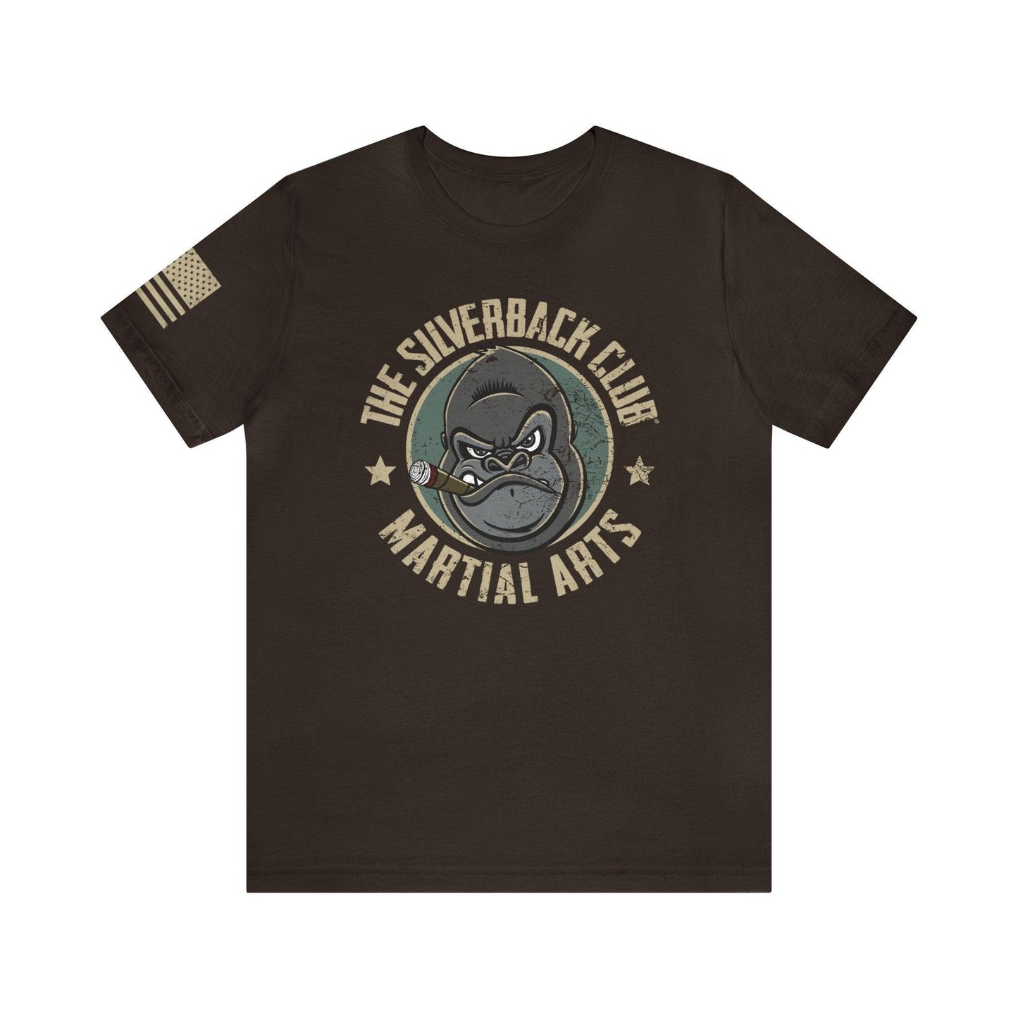 The front of a brown t-shirt and The Silverback Club logo consisting of a gorilla's face smoking a cigar and the words "Martial Arts" underneath.