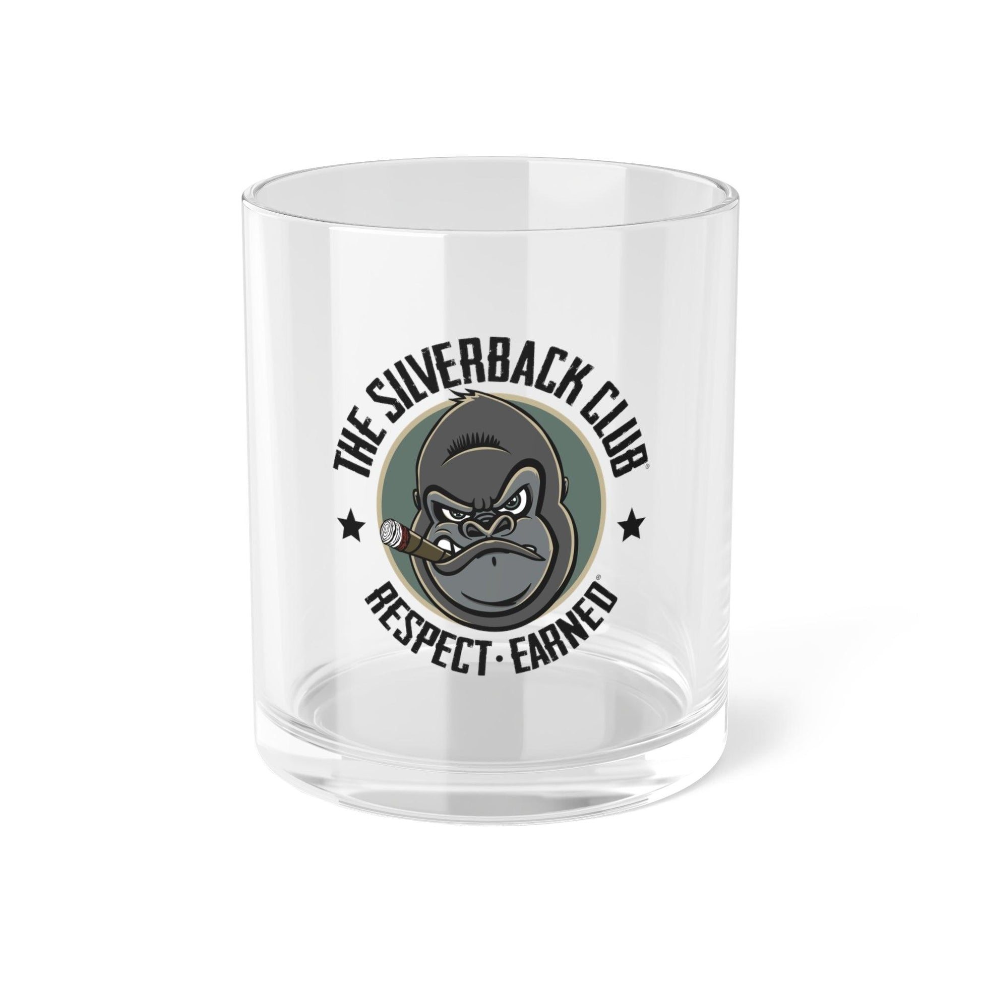 Front view of a whiskey glass with a logo of a silverback gorilla head smoking a cigar and the words The Silverback Club and Respect.Earned surrounding it.