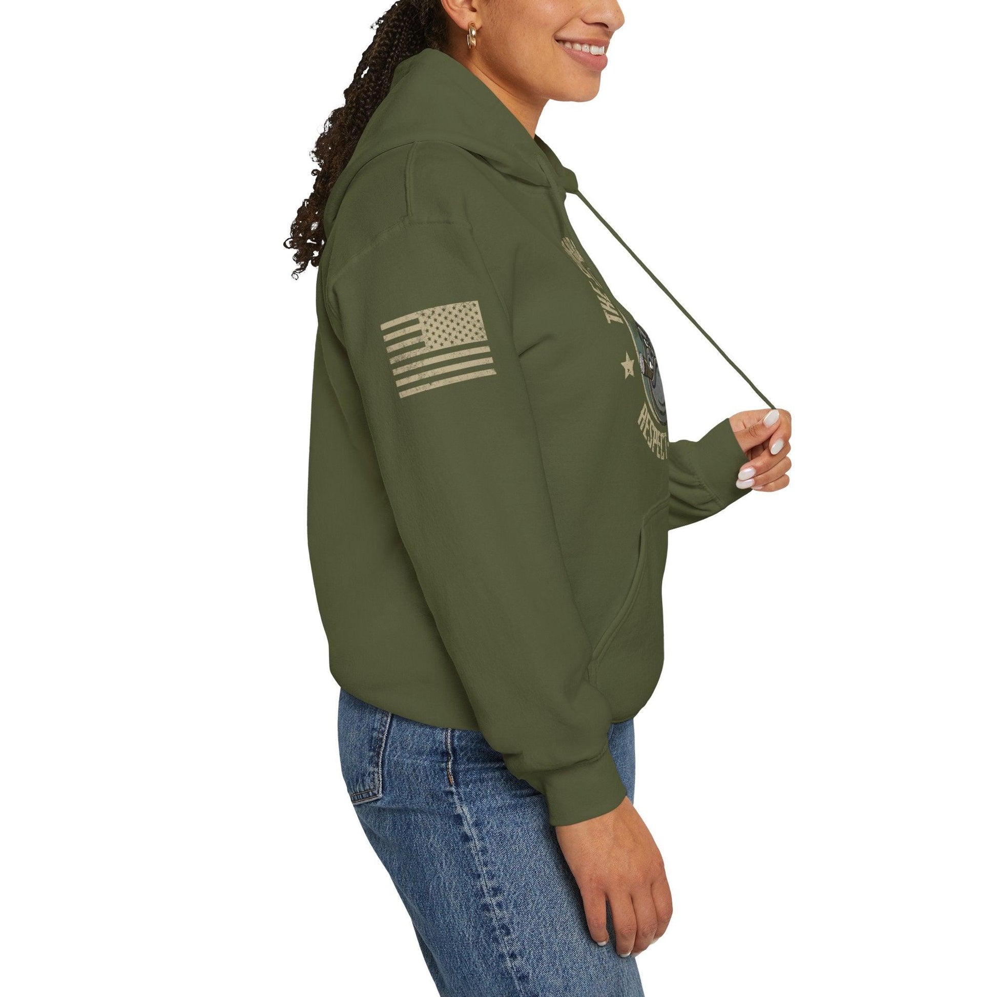 A side view of a woman wearing an olive green hooded sweatshirt with a U.S. flag graphic on the upper right arm.