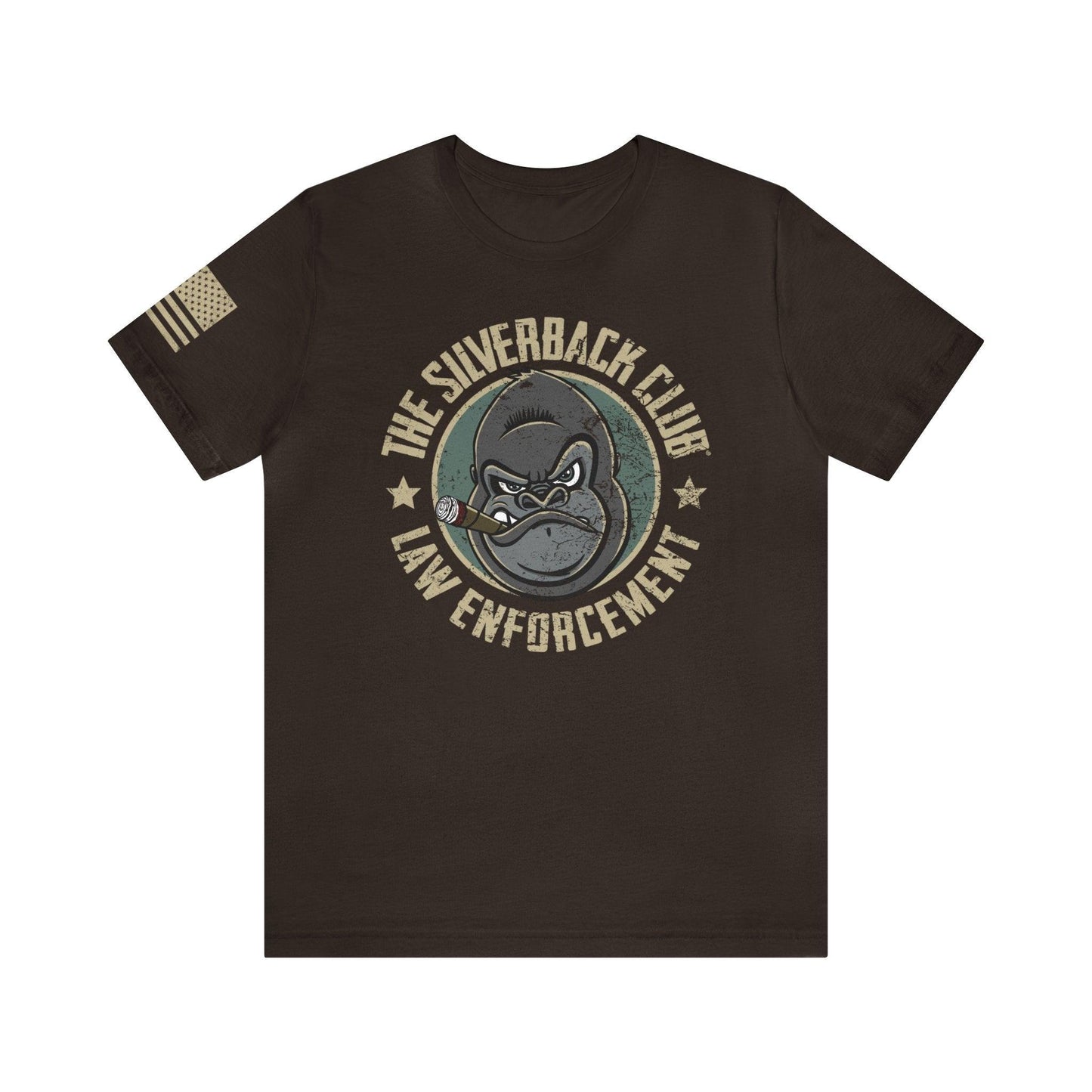 The front of a brown t-shirt and The Silverback Club logo consisting of a gorilla's face smoking a cigar and the words "Law Enforcement" underneath. The U.S. flag is on the right sleeve.