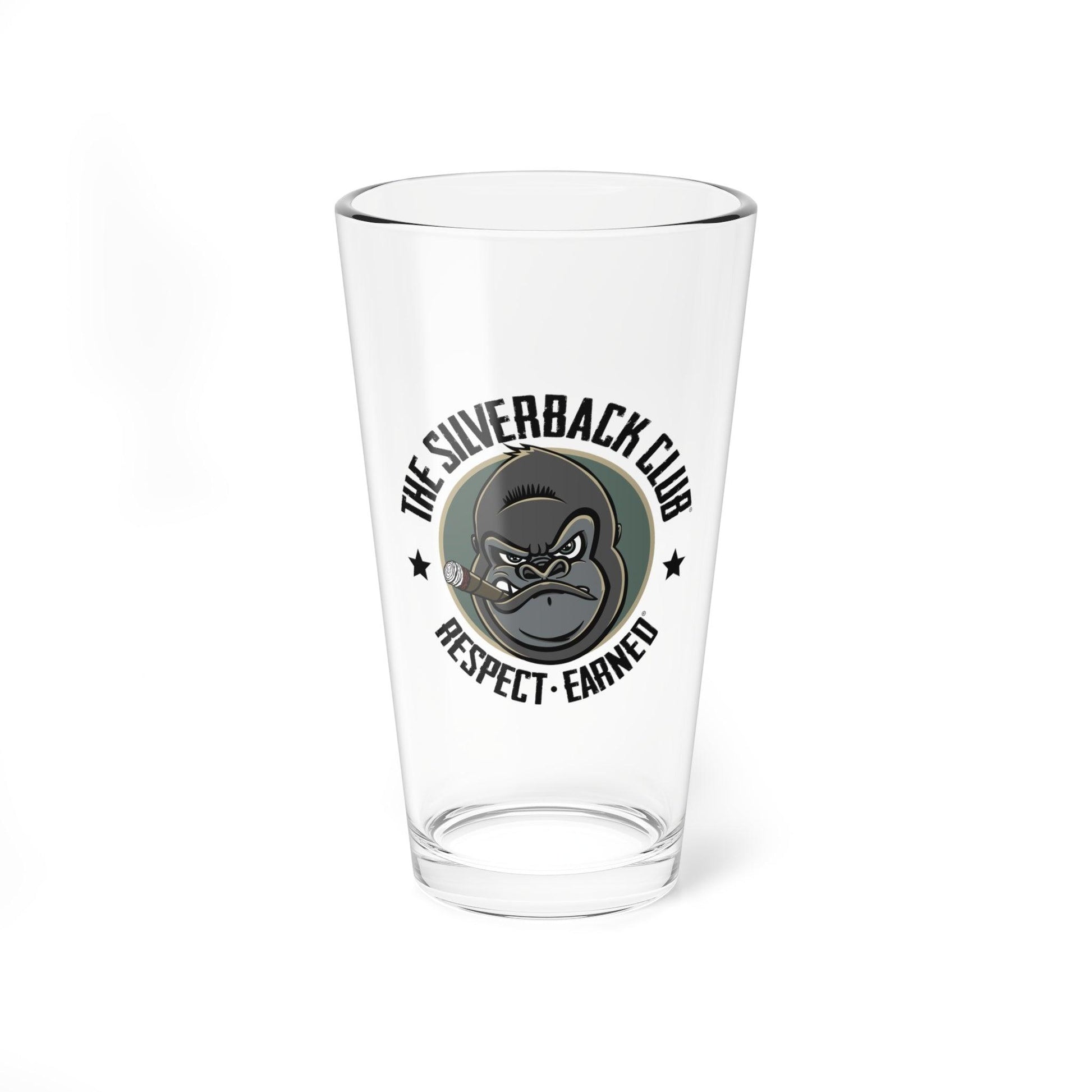 A front view of a tall glass with a logo of a silverback gorilla head smoking a cigar and the words The Silverback Club and Respect.Earned surrounding it.