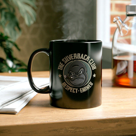 A black coffee mug with the logo of a gorilla smoking a cigar and the words, "The Silverback Club" and "Respect.Earned" surrounding it.