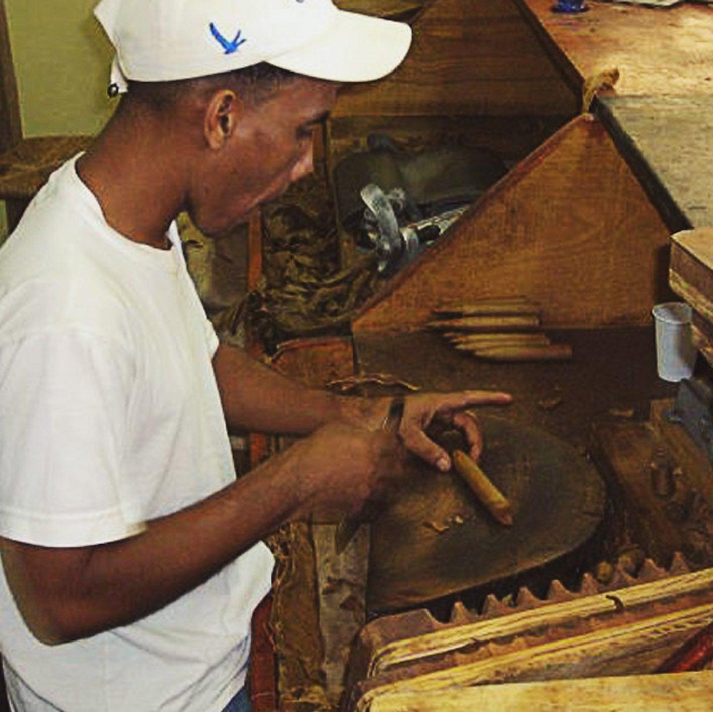 A man rolling a cigar.