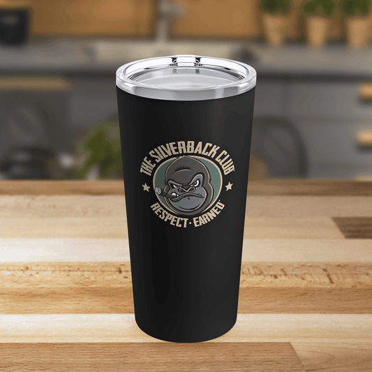 A black drink tumbler with a logo of a silverback gorilla head smoking a cigar and the words The Silverback Club and Respect.Earned surrounding it.
