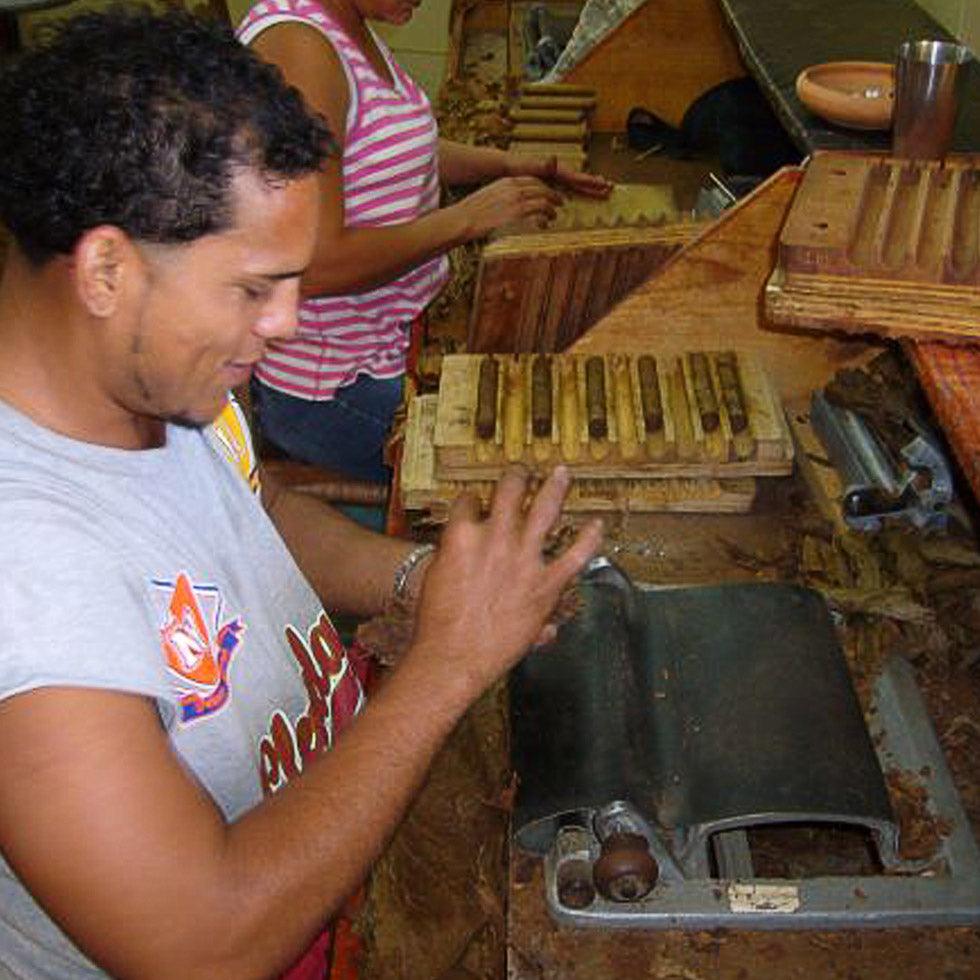 A man rolling a cigar.